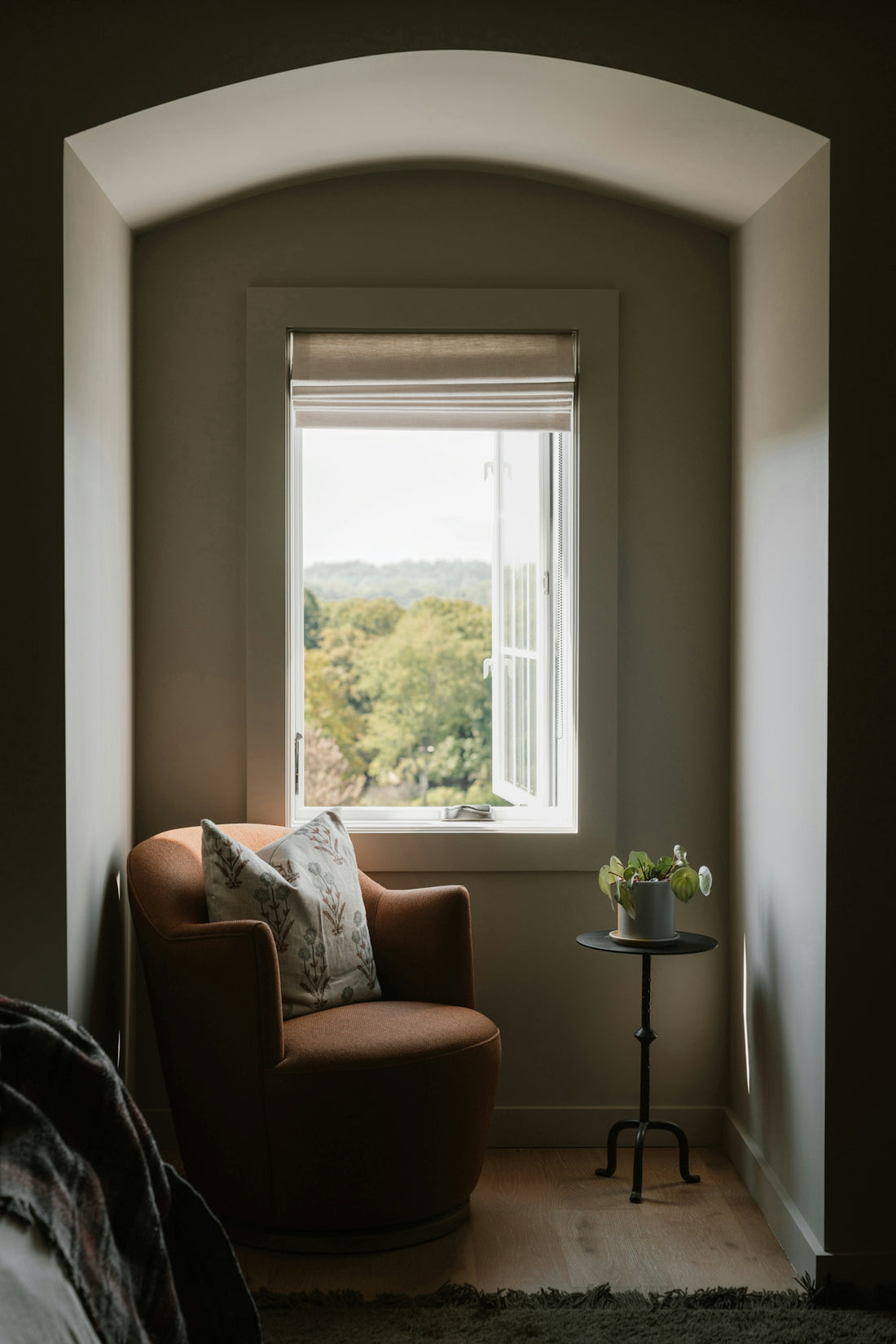 Cozy armchair by a window with a garden view